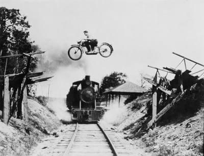 Historical bravery motorcycle jumping steam train