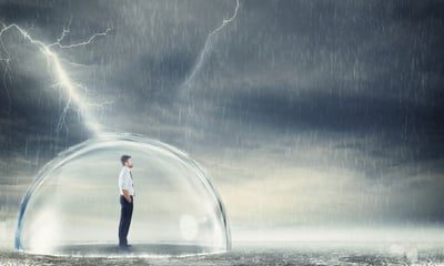 Man in bubble sheltered from storm