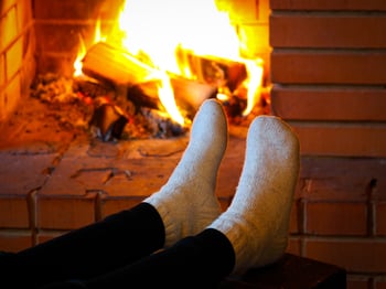 Sock feet by fireplace