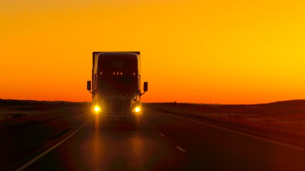 Truck driving at sunset